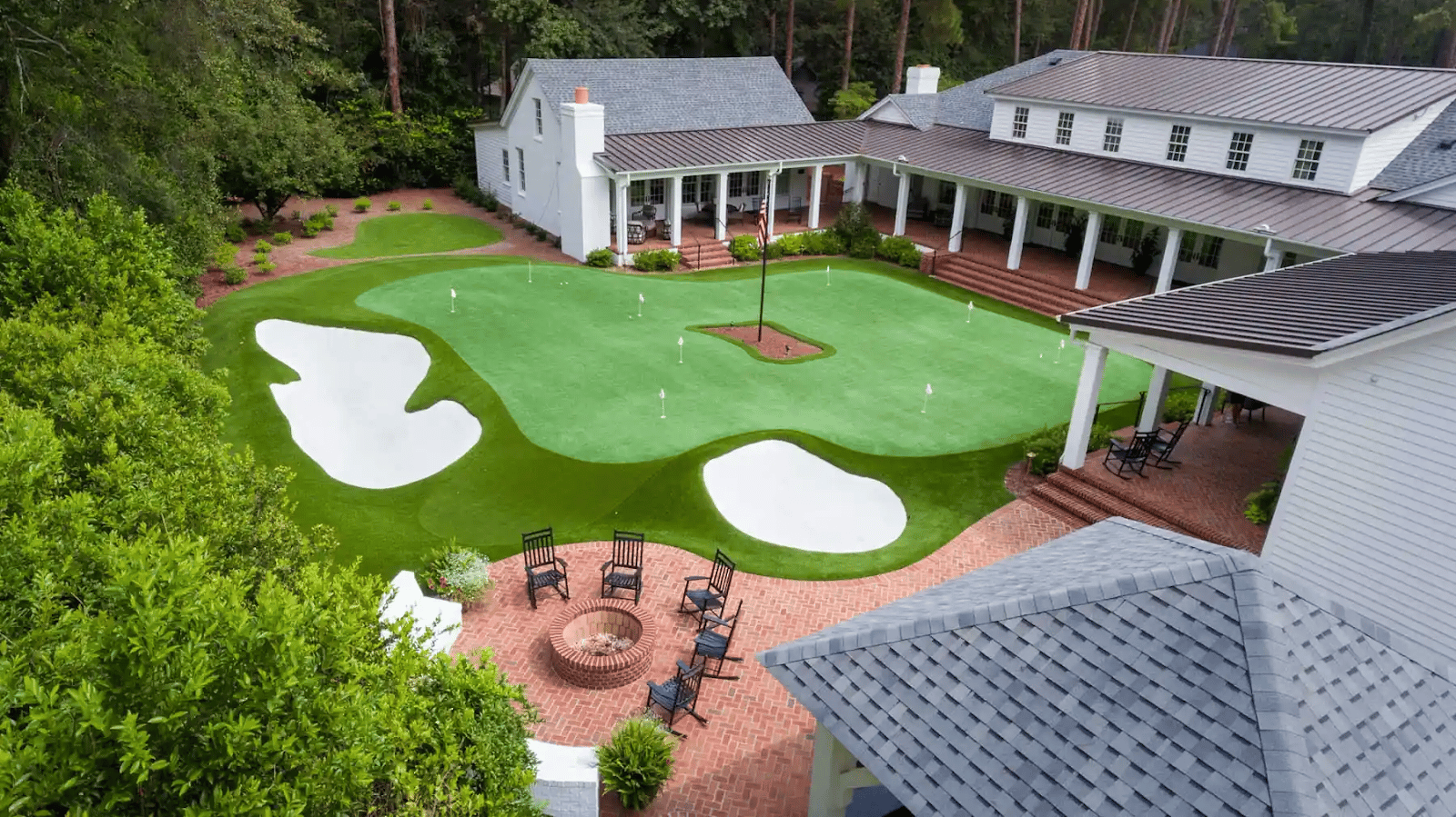 Premium backyard putting green with clean fringe border and multiple cups
